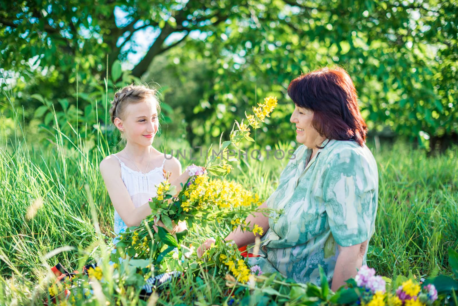 Grandmother and granddaughter with flowers by okskukuruza