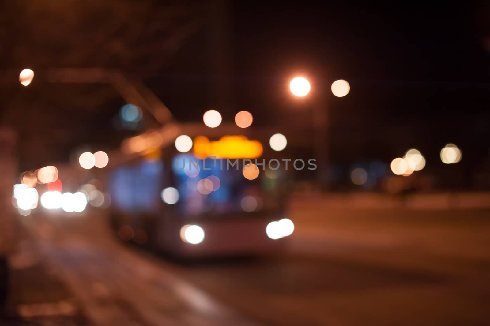 trolley bus on the night city street.