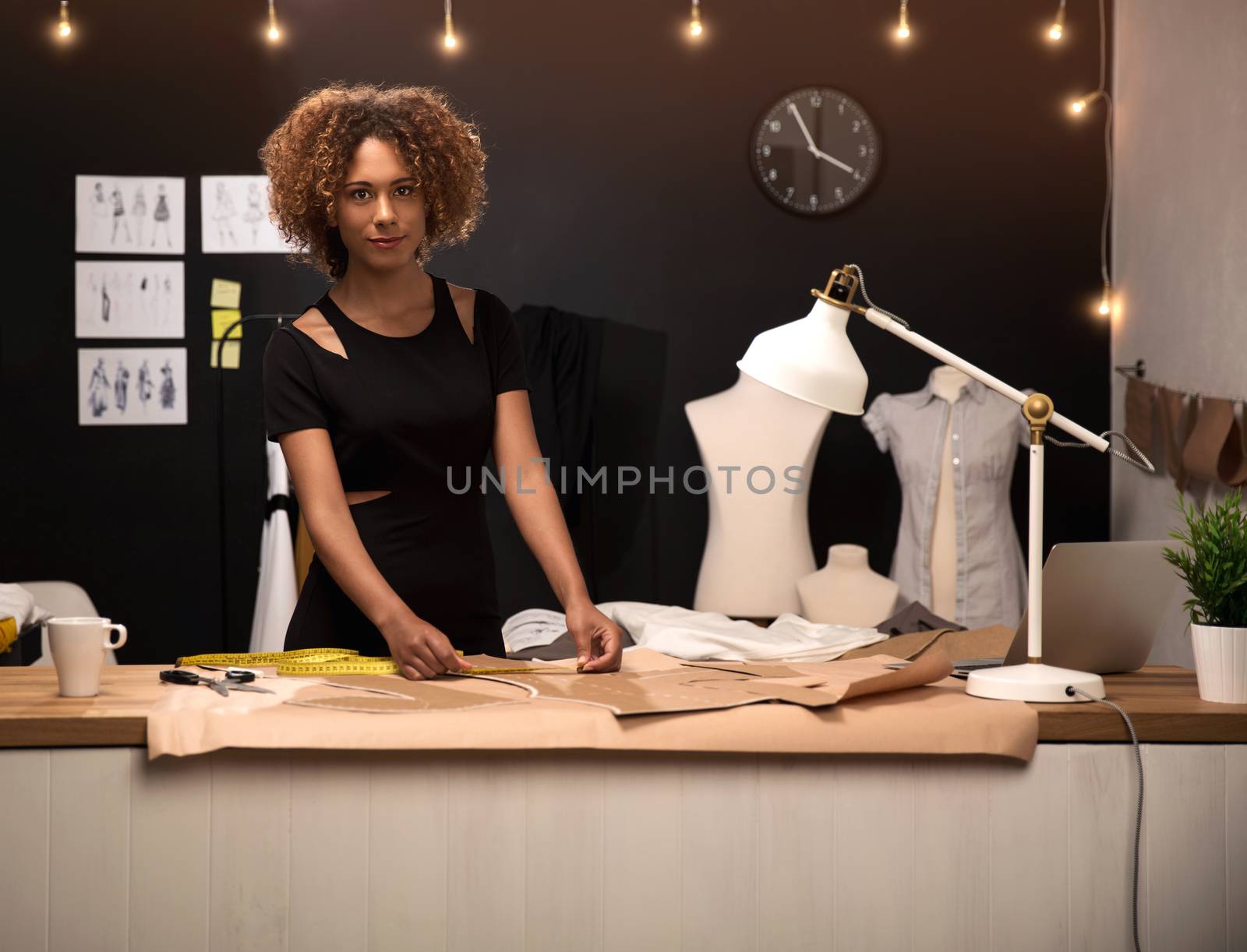 A young fashion designer working on her atelier