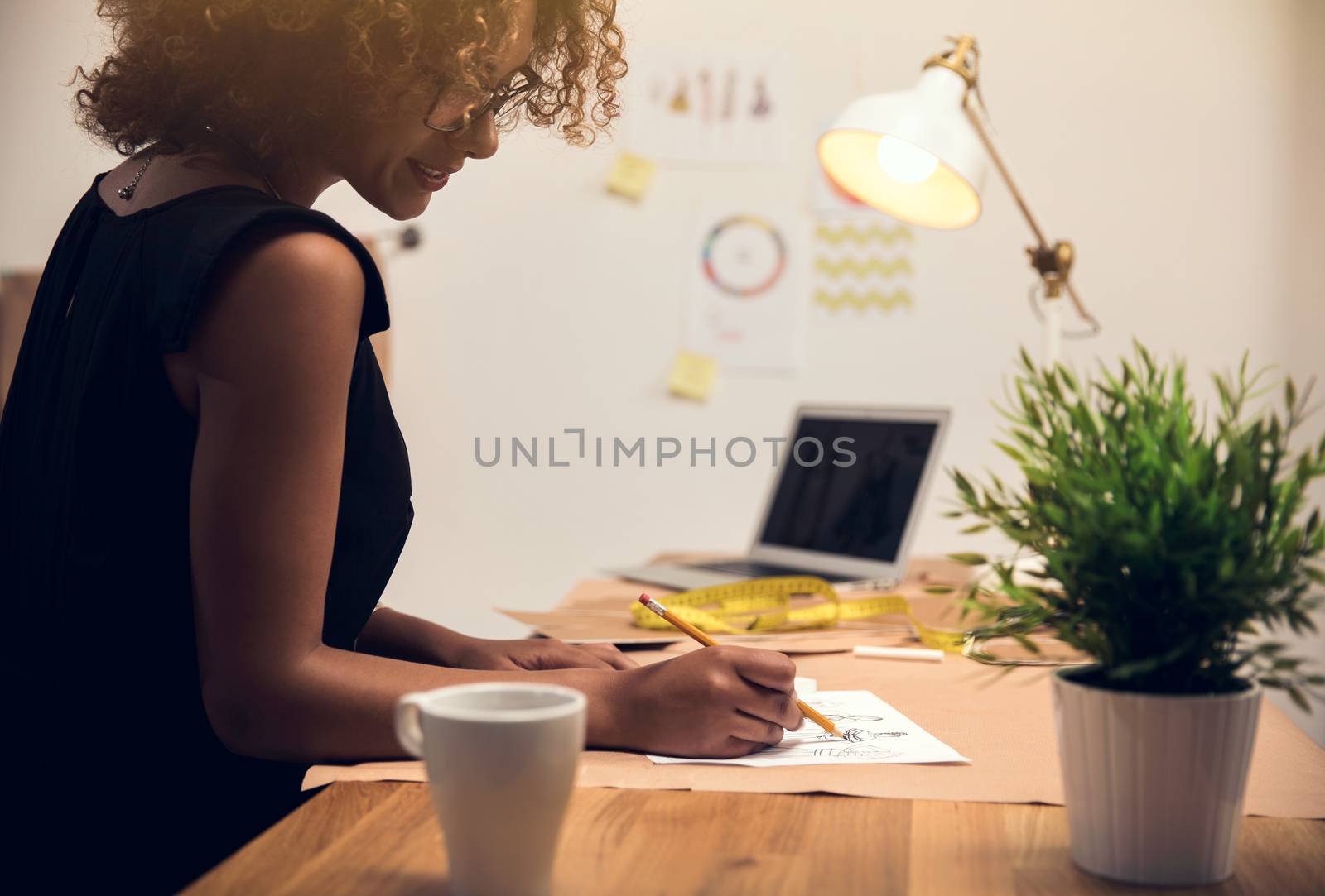 A young fashion designer working on her atelier