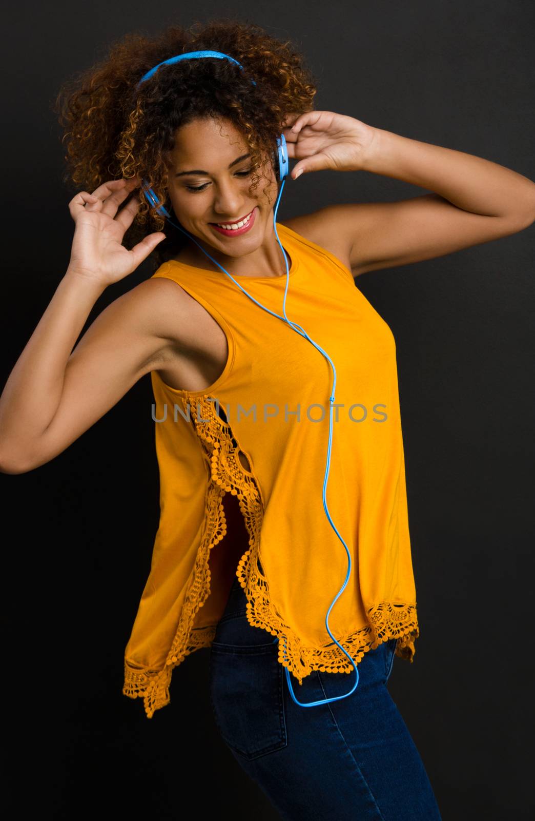 Beautiful African American woman listen  music and dancing