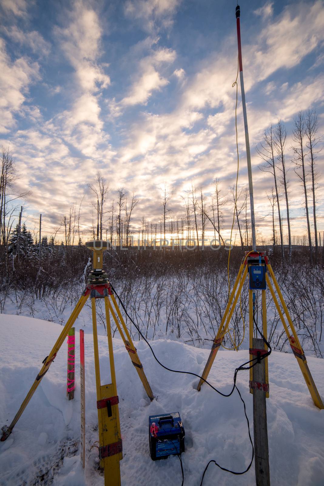 Survey equipment set up in snow at sunset canada