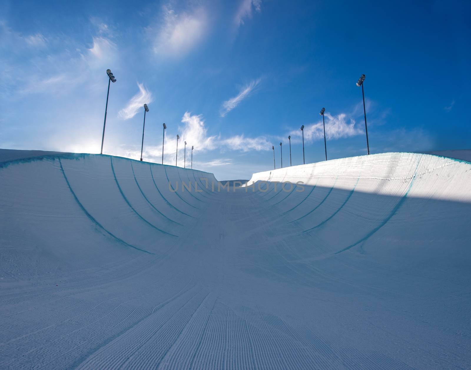 Empty winter snow halfpipe on a sunny day