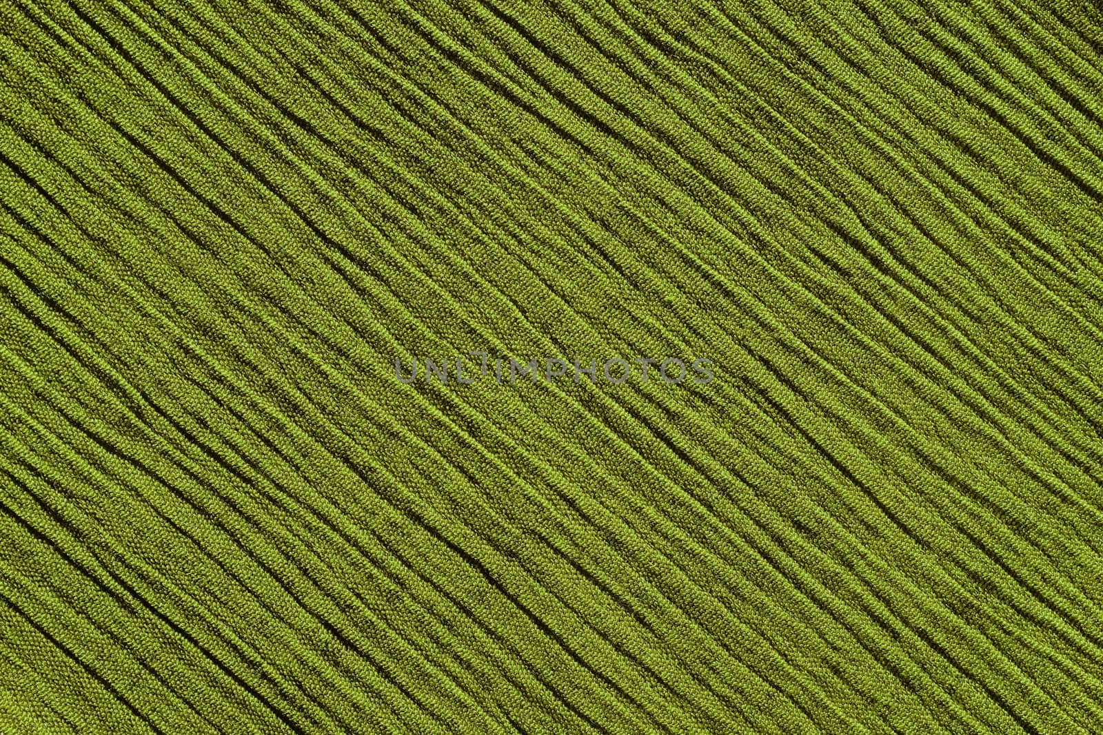 Light green crinkled fabric with irregular diagonal lines textile abstract background texture
