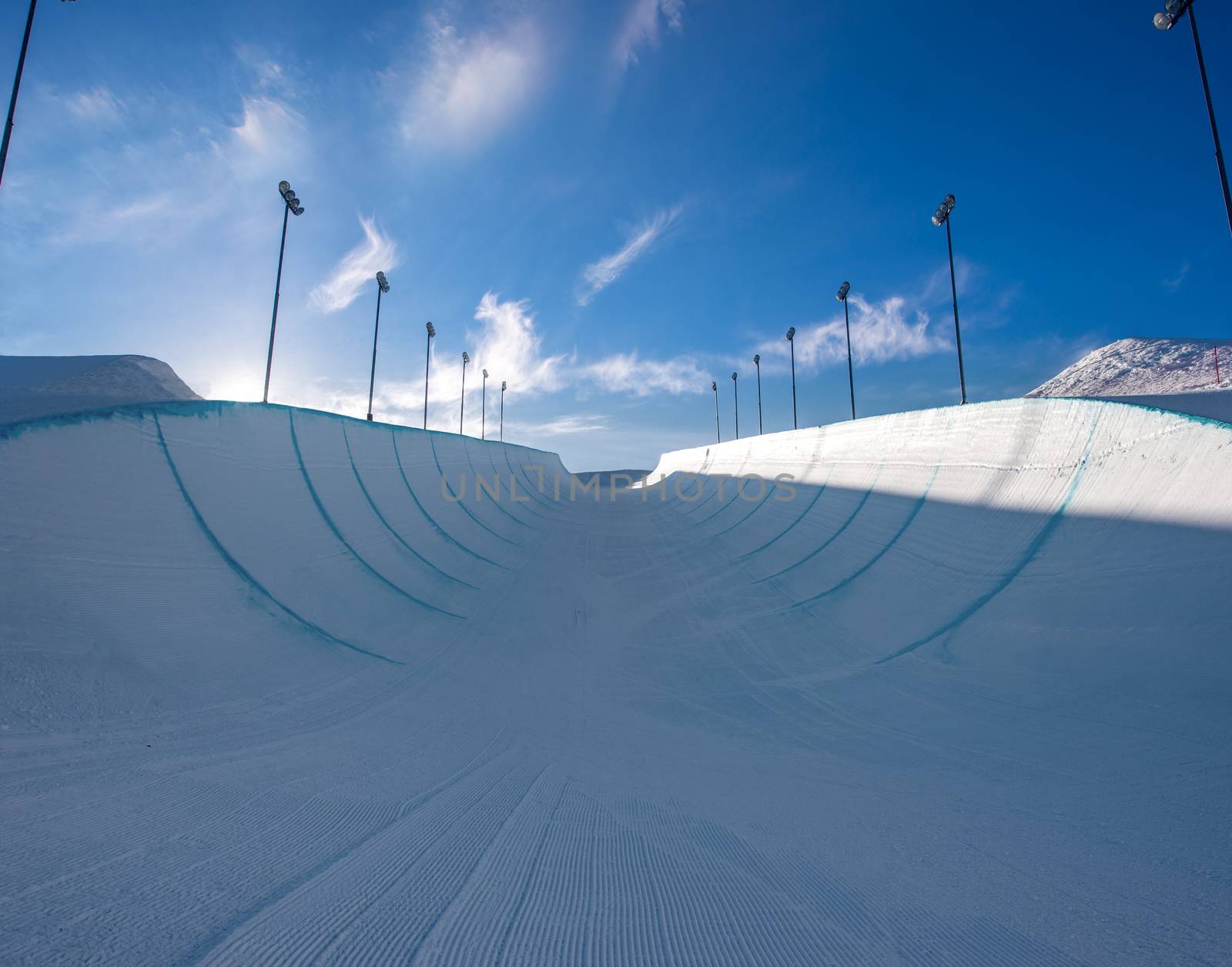 Empty winter snow halfpipe on a sunny day