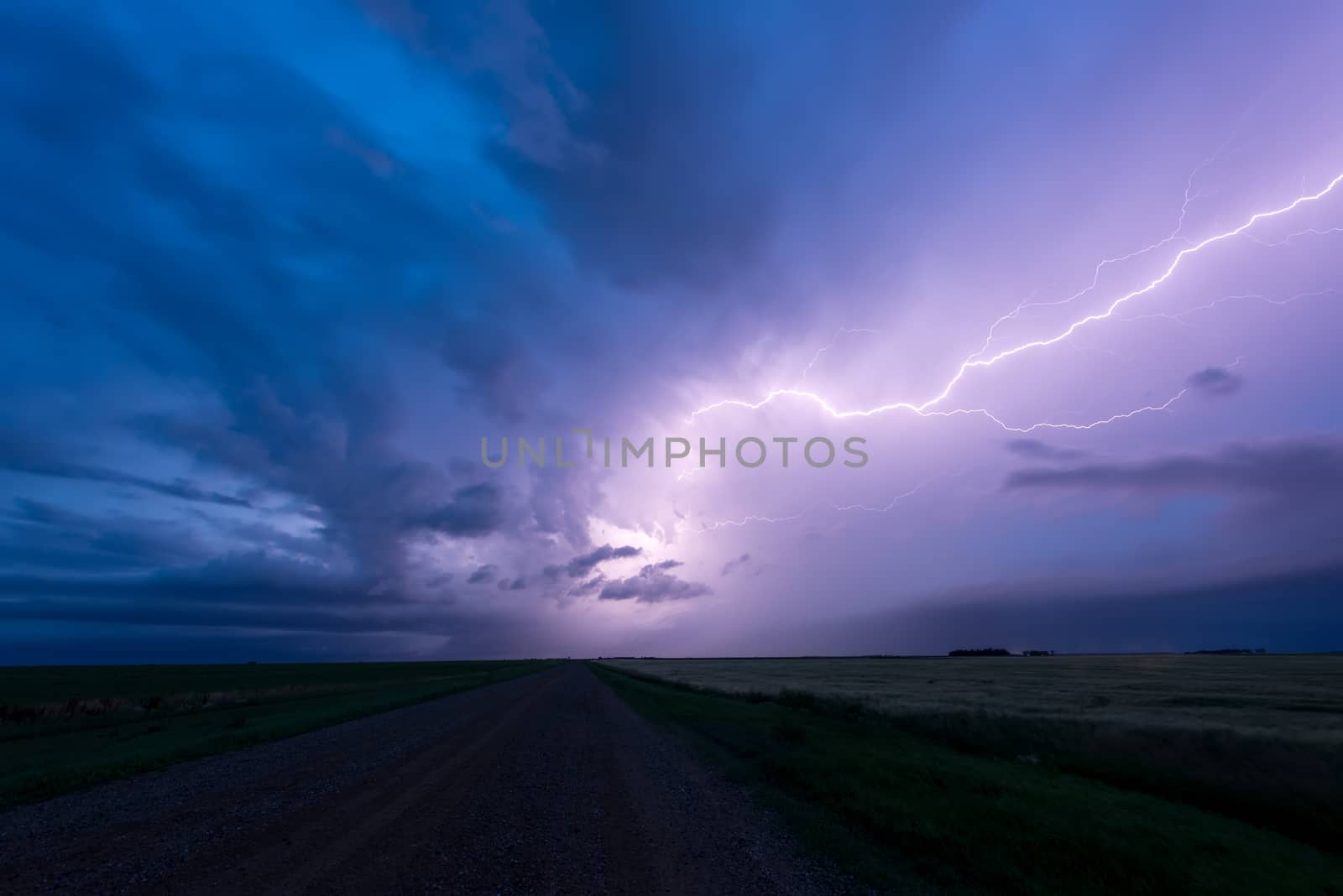 Lightning across the sky above a road in the prairies