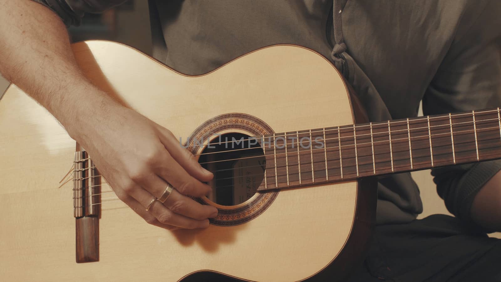 Hands of guitarist playing a guitar by Chudakov