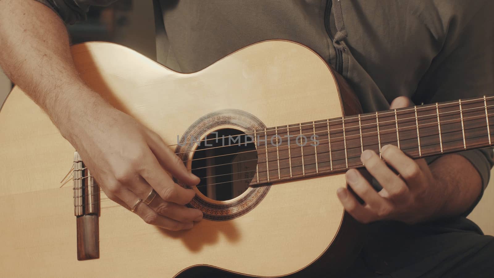 Hands of guitarist playing a guitar. Close-up