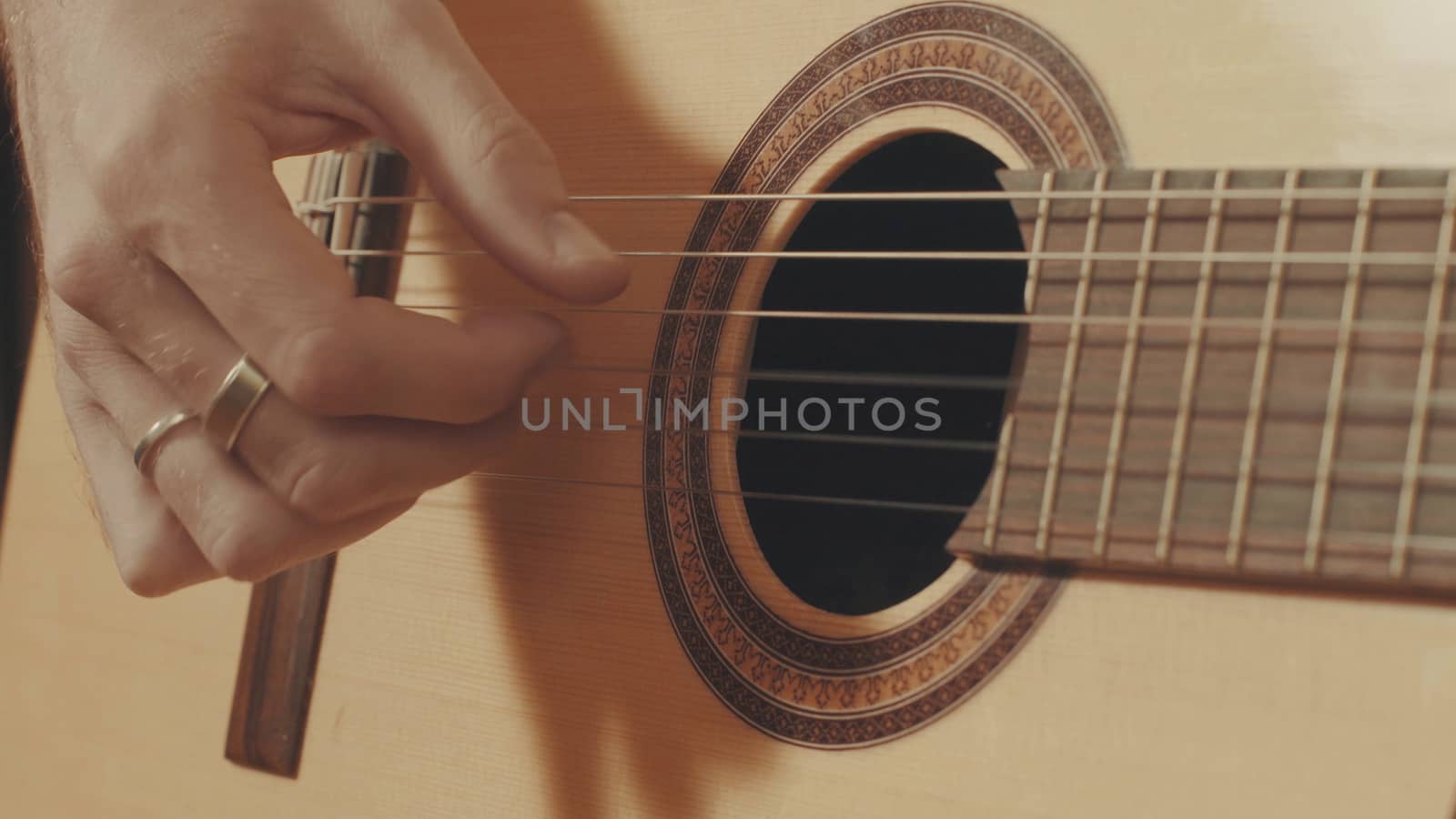 Hands of guitarist playing a guitar. Close-up