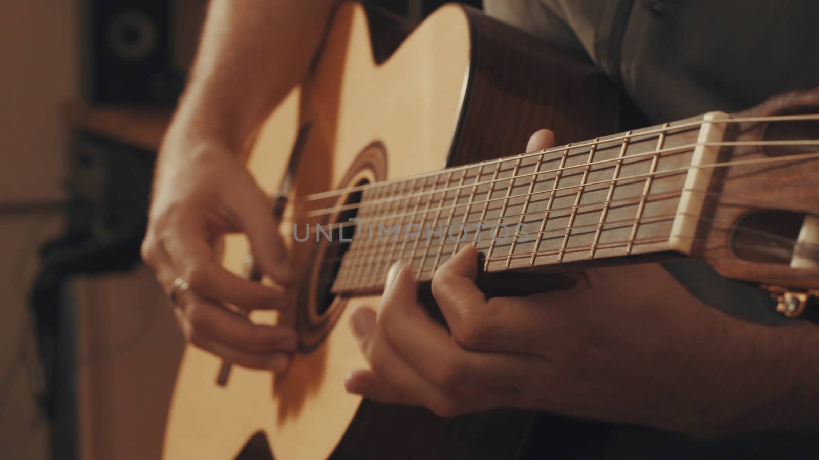 Hands of guitarist playing a guitar. Close-up