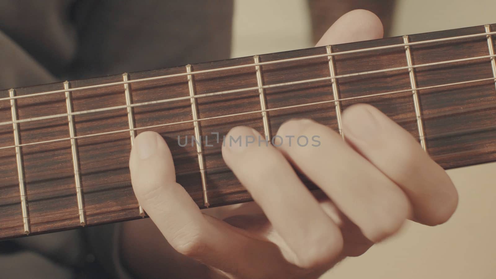 Hands of guitarist playing a guitar. Close-up