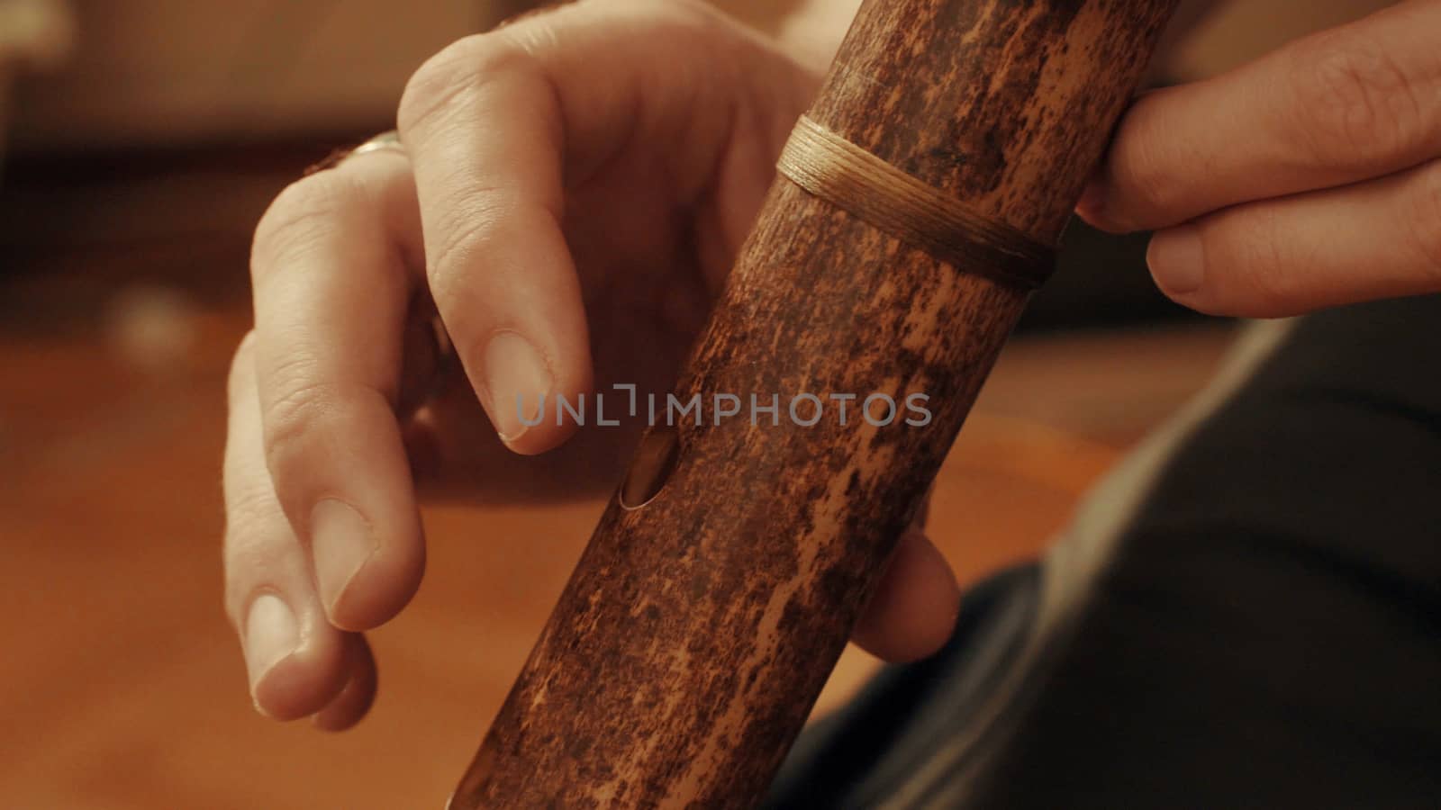 Hands of musician plays the flute. Close up