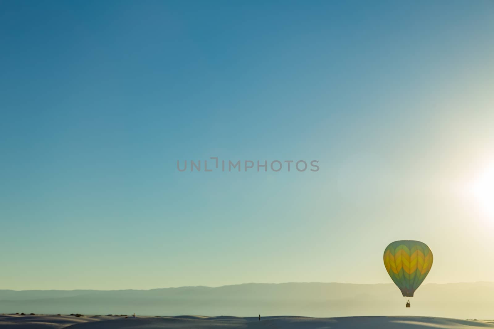 Colorful hot air balloons fly over the glistening gypsum dunes at White Sands National Monument during the 2016 Balloon Invitational.