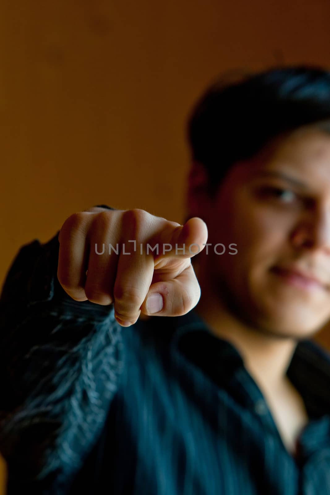 Young man pointing a finger to camera by Chudakov