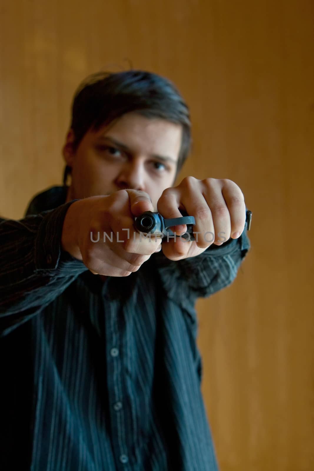 Armed man pointing a gun in camera