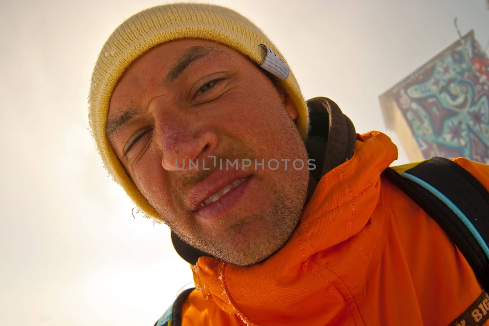 Funny portrait of sportsman in orange parka