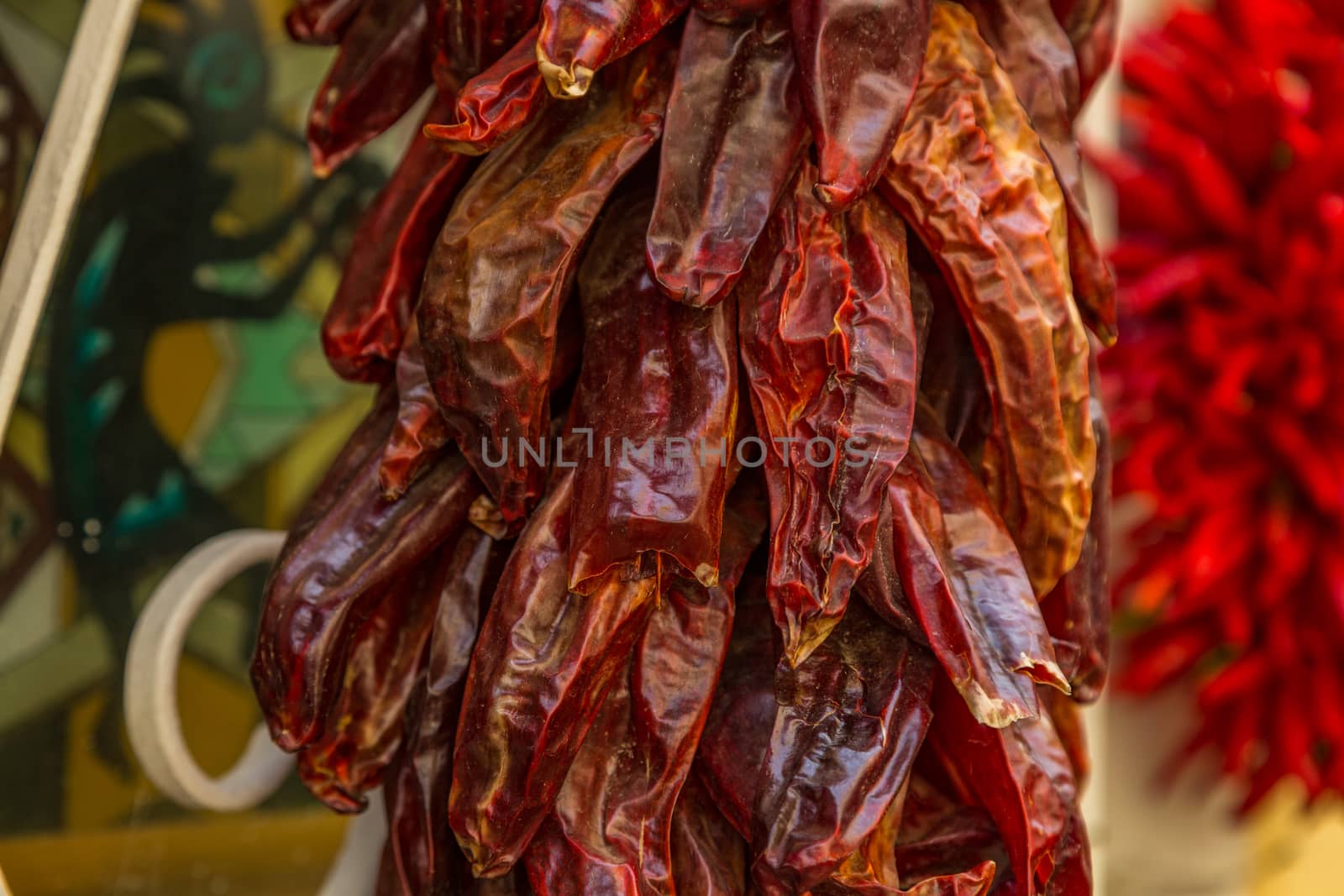A ristra is an arrangement of drying chile pepper pods, garlic bulbs, or other vegetables for later consumption. In addition to its practical use, the ristra has come to be a trademark of decorative design in the state of New Mexico.