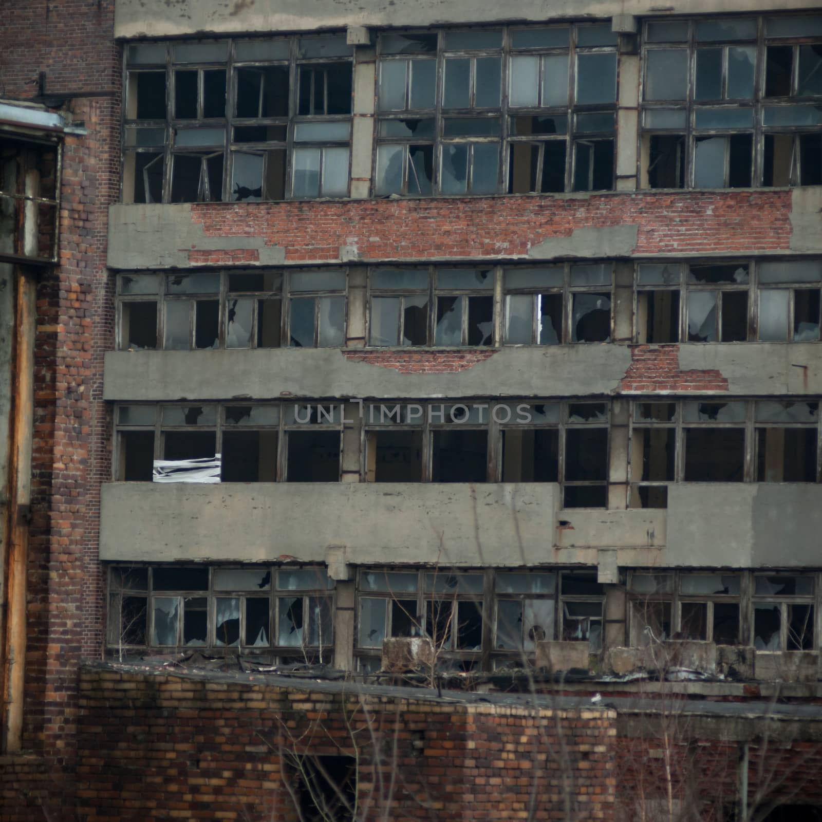 discarded ruin with old windows and wall, industrial window in concrete wall
