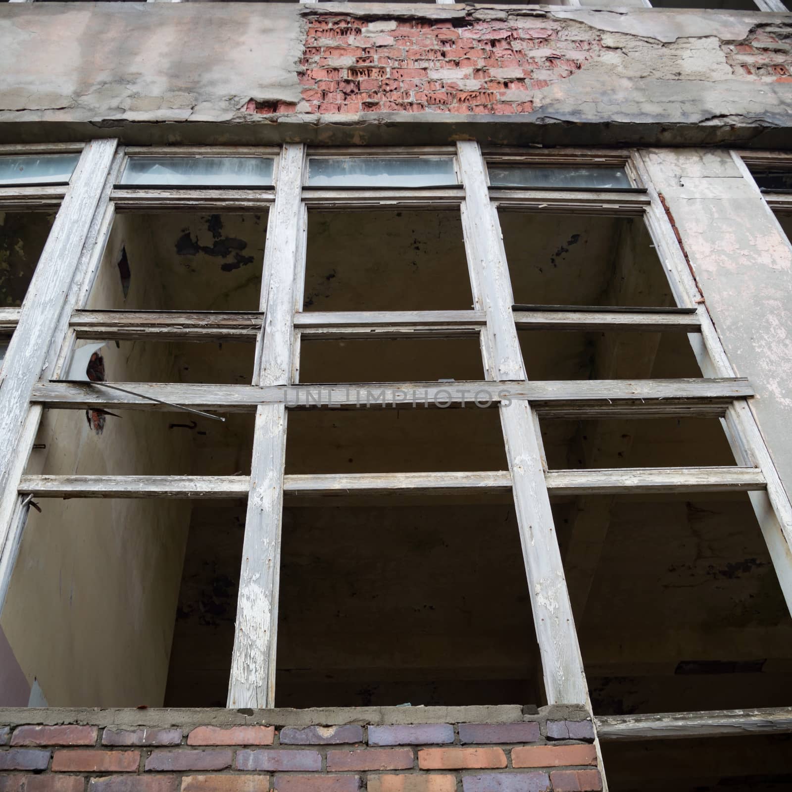 discarded ruin with old windows and wall, industrial window in concrete wall