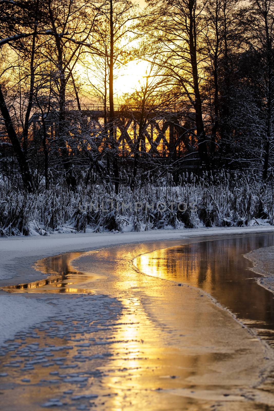 Colorful evening with golden reflection on the winter river