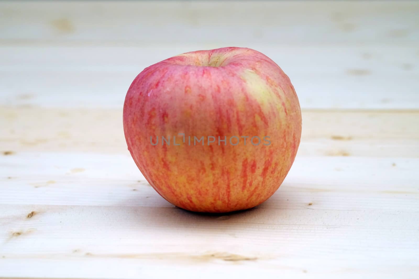 one red Apple on the Table Wood