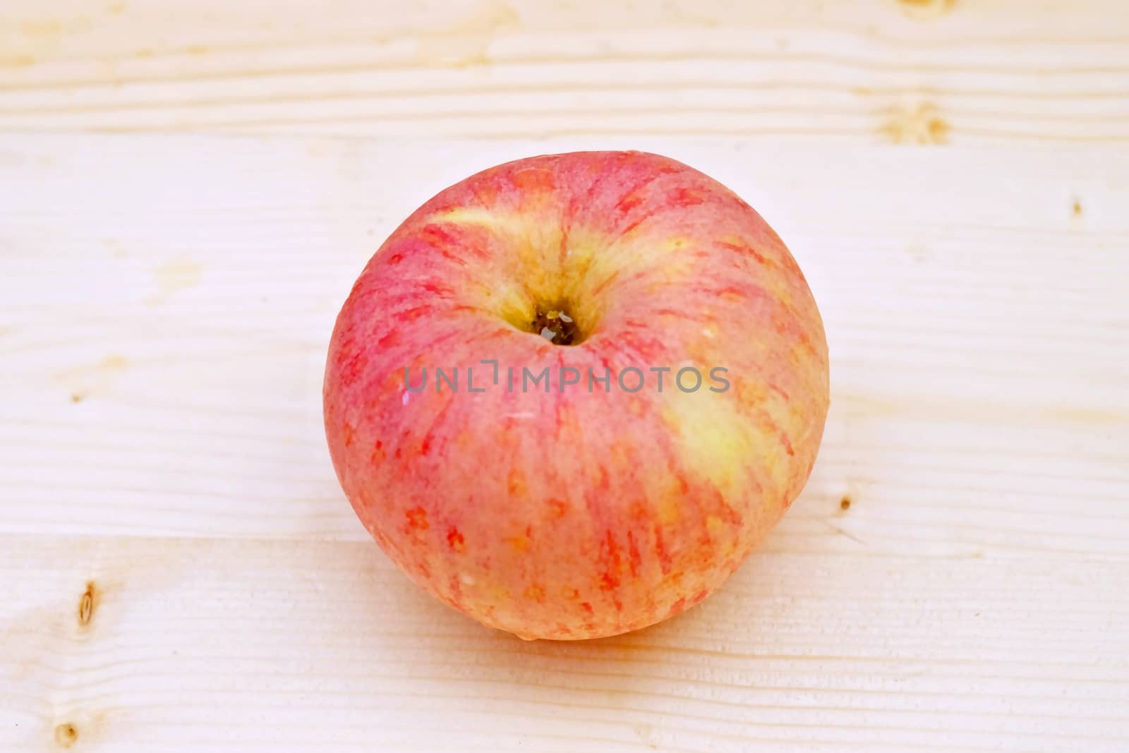 one red Apple on the Table Wood