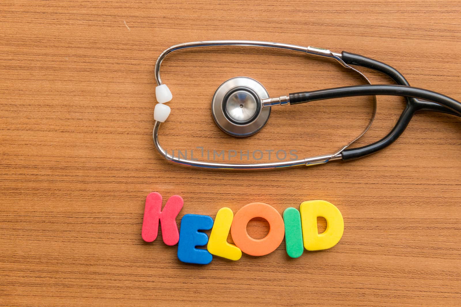 keloid colorful word with Stethoscope on wooden background