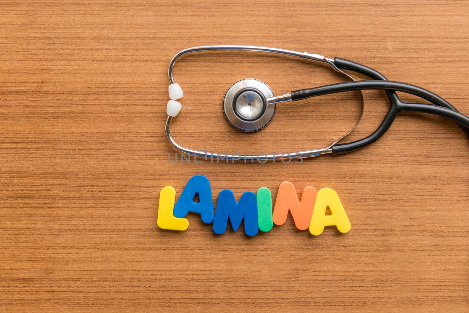lamina colorful word with Stethoscope on wooden background