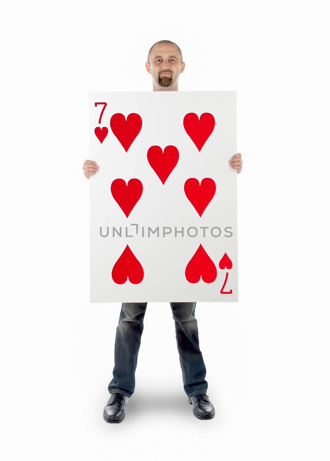 Businessman with large playing card - Seven of hearts