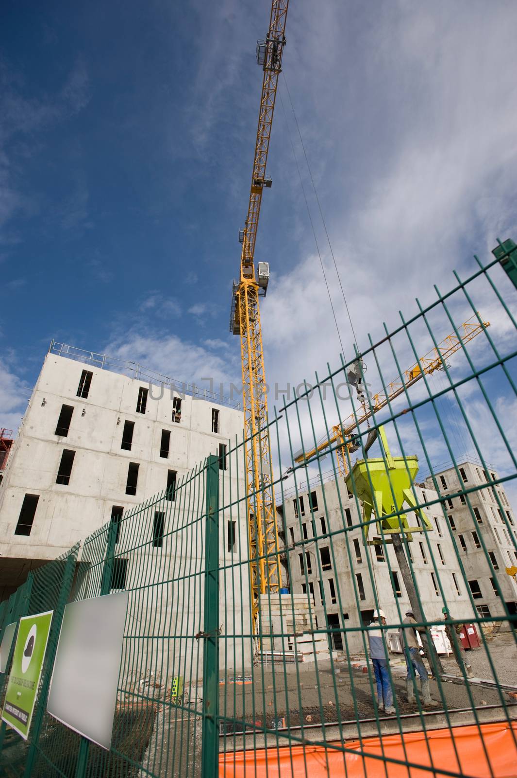 the construction crane and the building against the blue sky, France