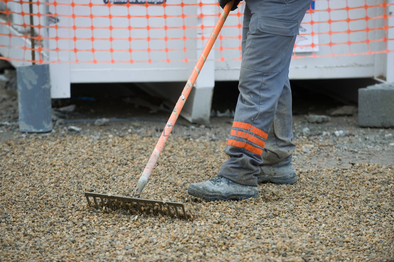 Construction workers sweeping in the installation, Gravel