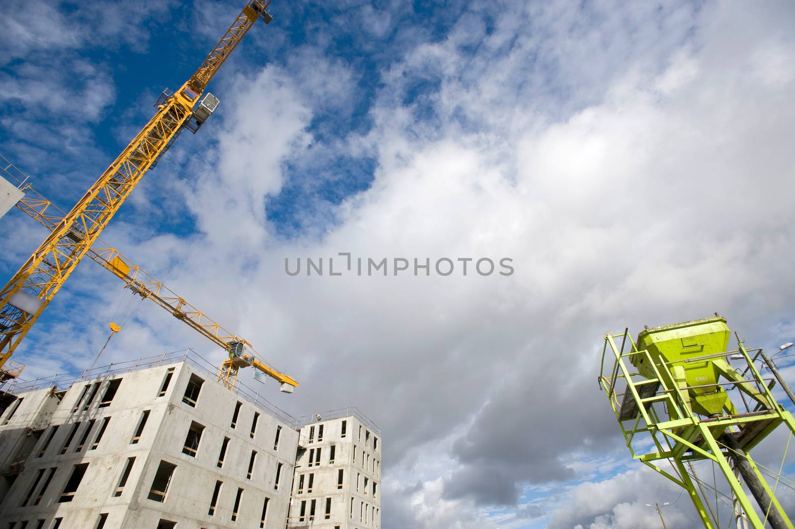 the construction crane and the building against the blue sky, France