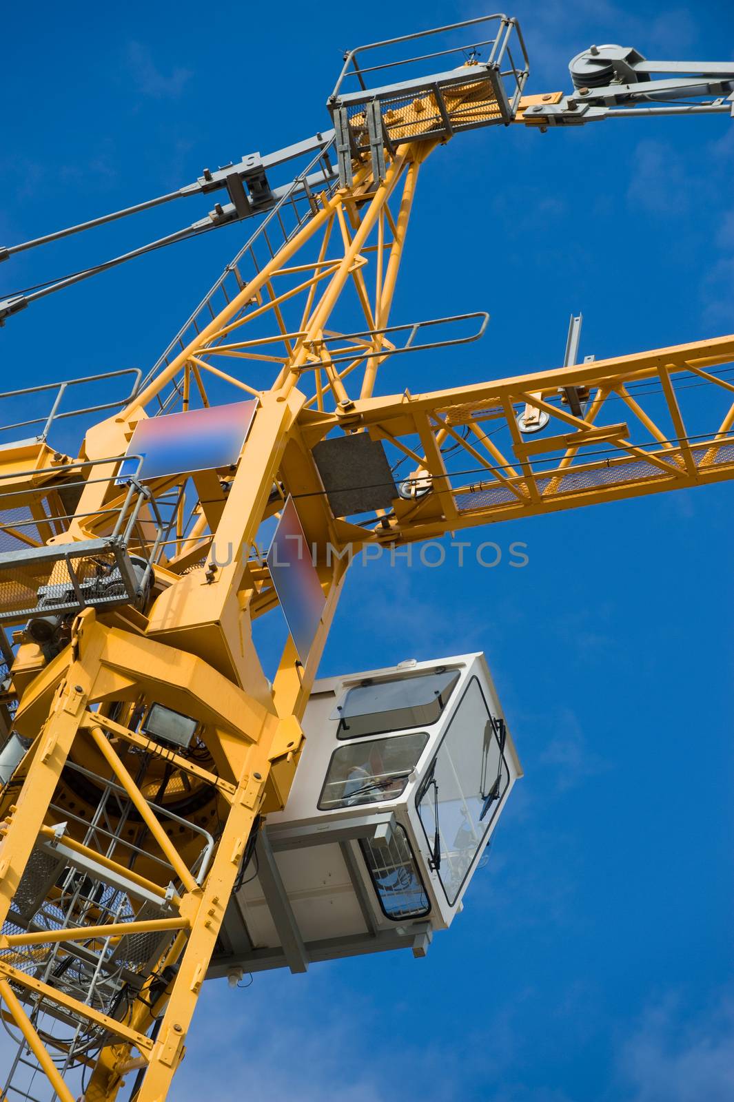 the construction crane and the building against the blue sky, France