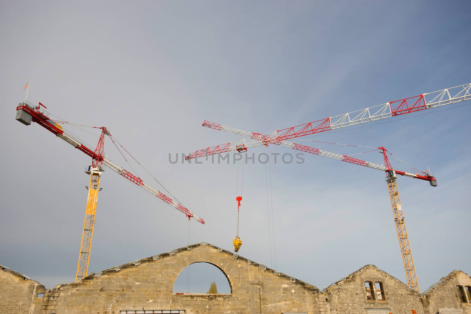 the construction crane and the building against the blue sky, France
