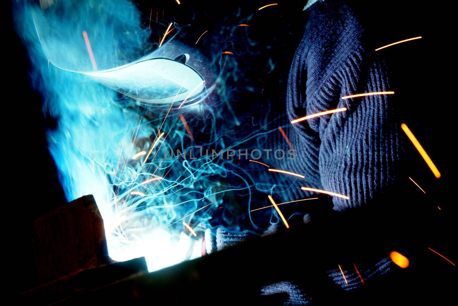 Arc welder with welding sparks on black background