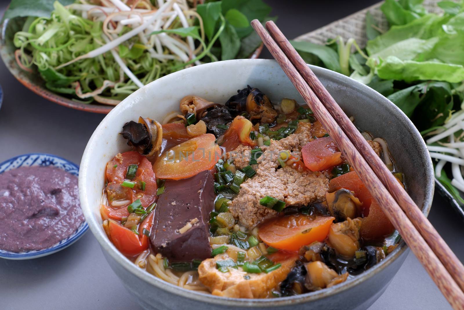 Vietnamese food, bun rieu and canh bun, is popular street food cook from crab, tofu, vermicelli eat with shrimp paste, vegetables, is delicious and cheap dish