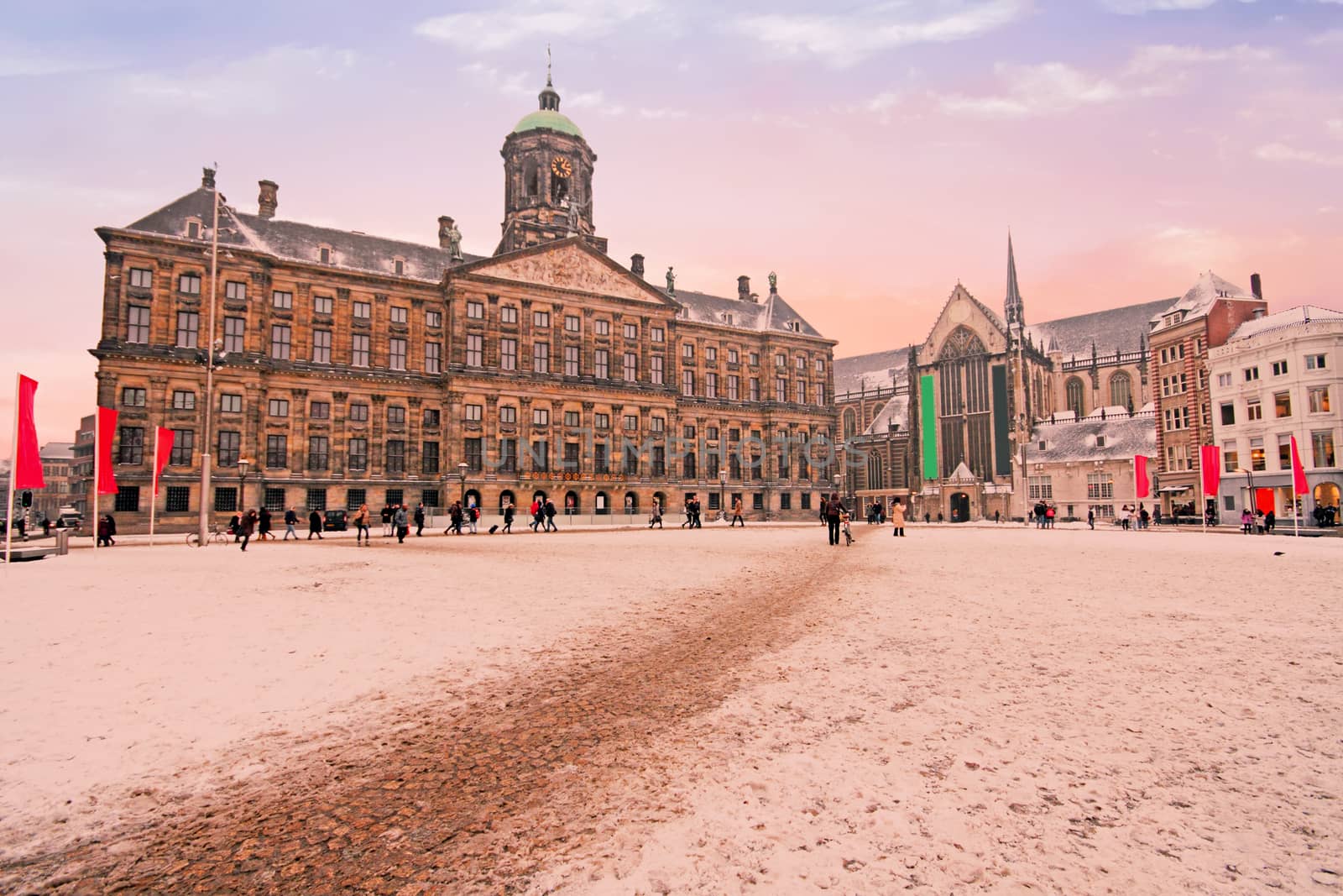 Snowy Damsquare in Amsterdam the Netherlands in winter at sunset