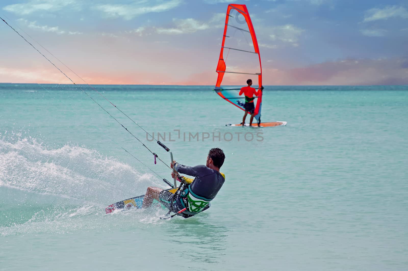 Kite surfer on Aruba island in the Caribbean at sunset