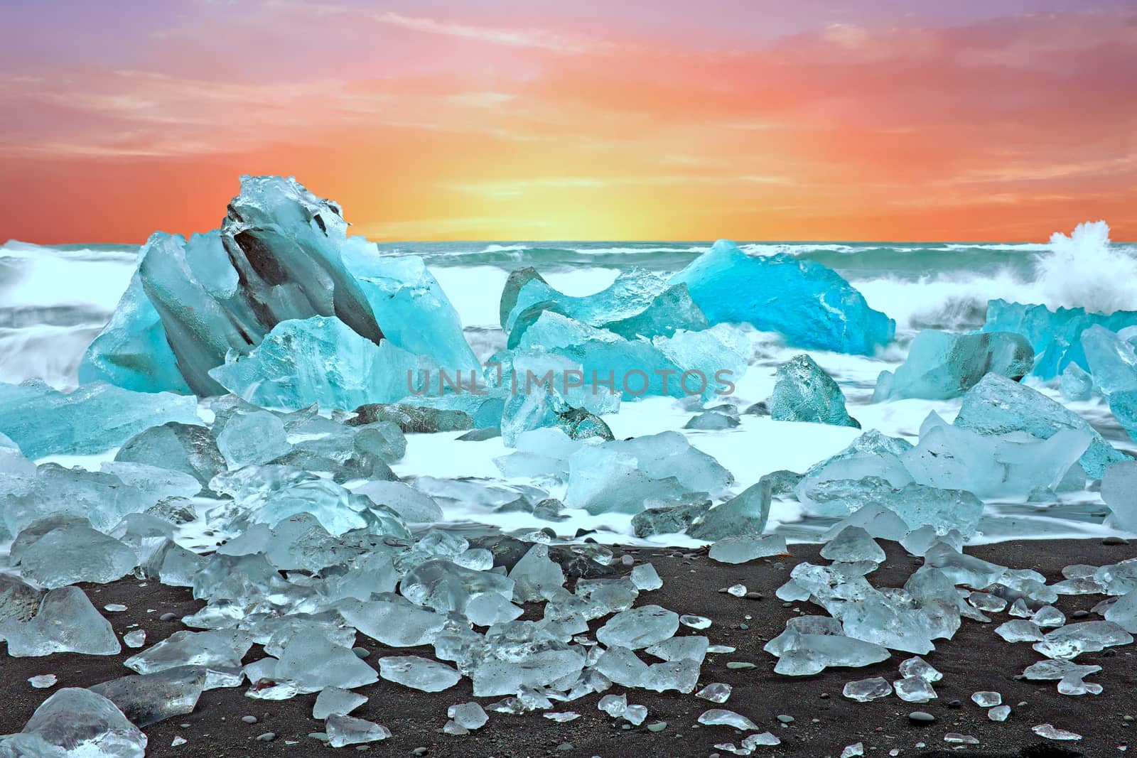 Ice rocks on a black sand beach at Jokulsarlon in Iceland at twilight
