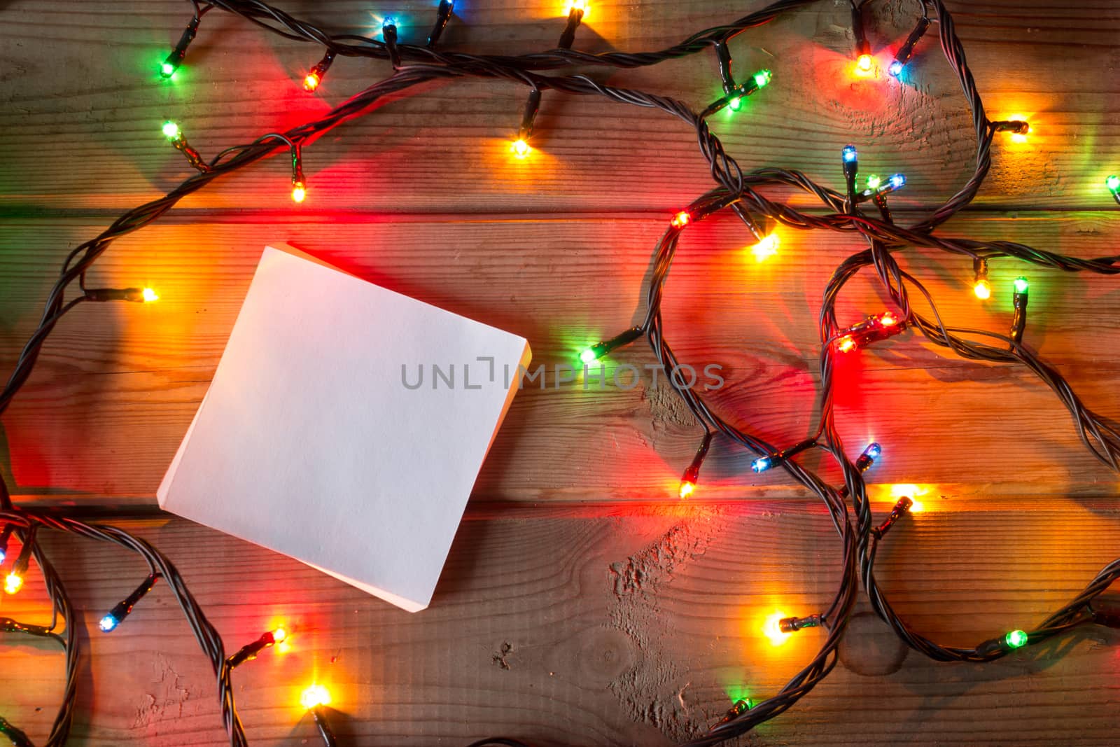 Christmas tree garland and balls on wooden table mock up by liwei12