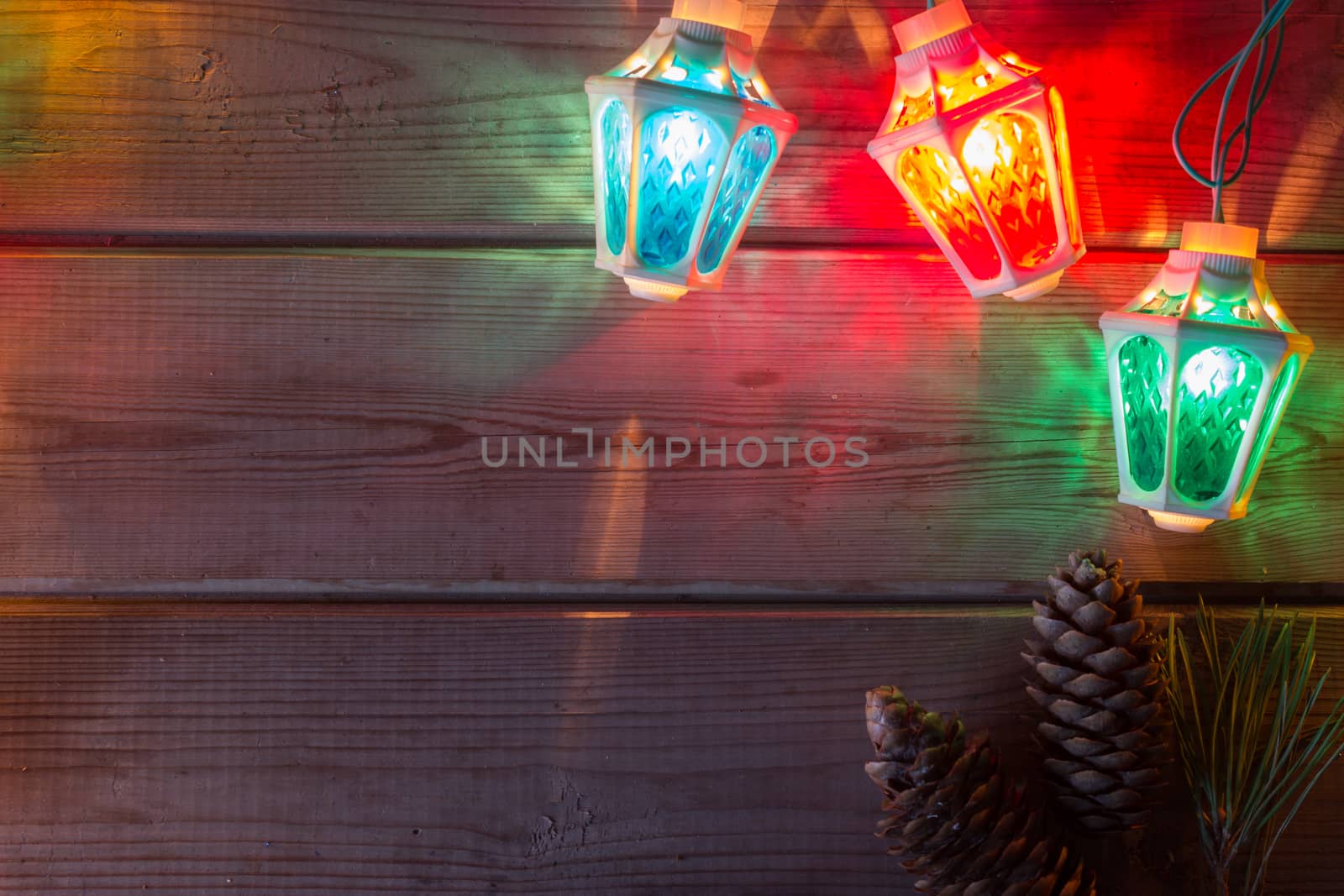 Christmas tree garland, Christmas tree branches and Christmas balls on wooden table mock up