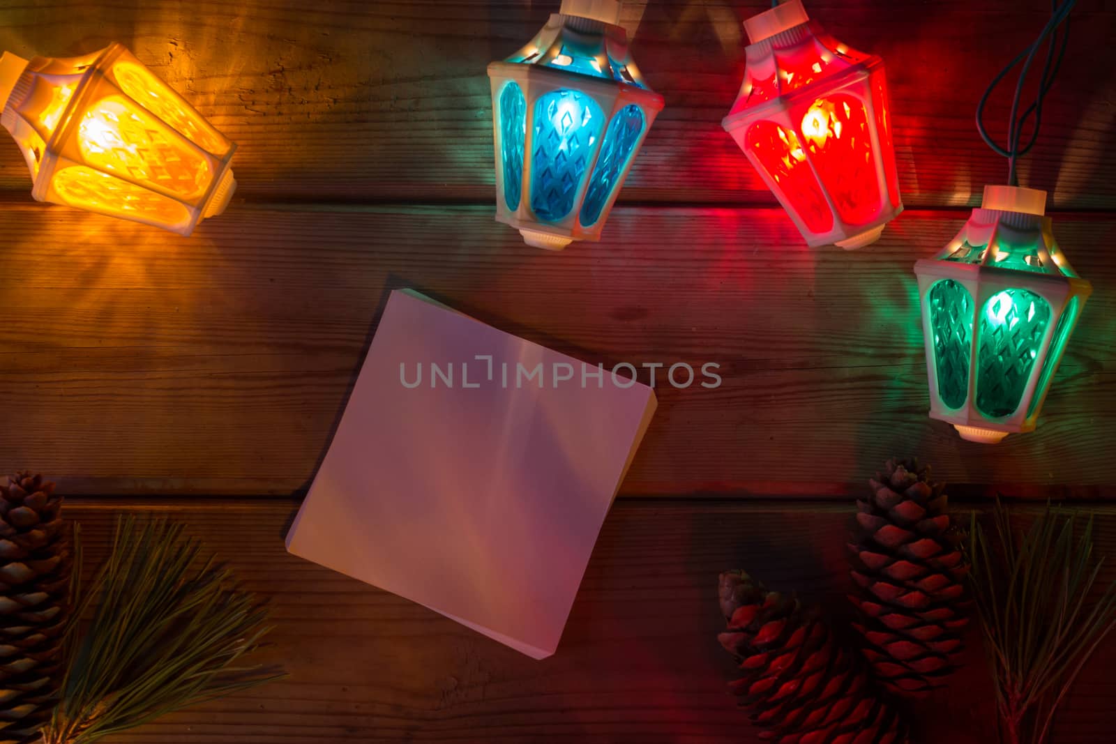 Christmas tree garland and balls on wooden table mock up by liwei12