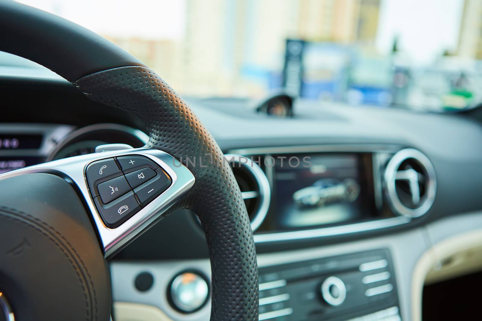 Control buttons on the steering wheel of a car.