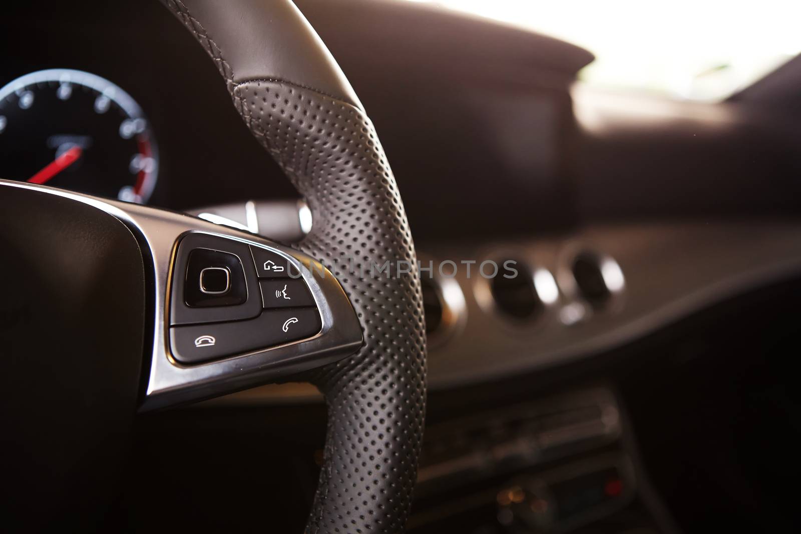 Control buttons on the steering wheel of a car.