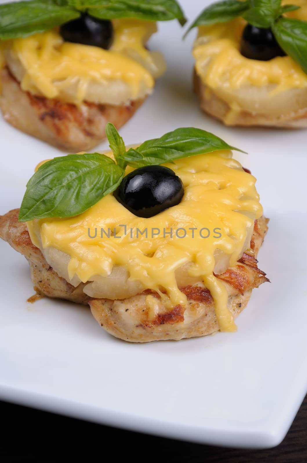 pieces of chicken fillet    a slice of pineapple with cheese