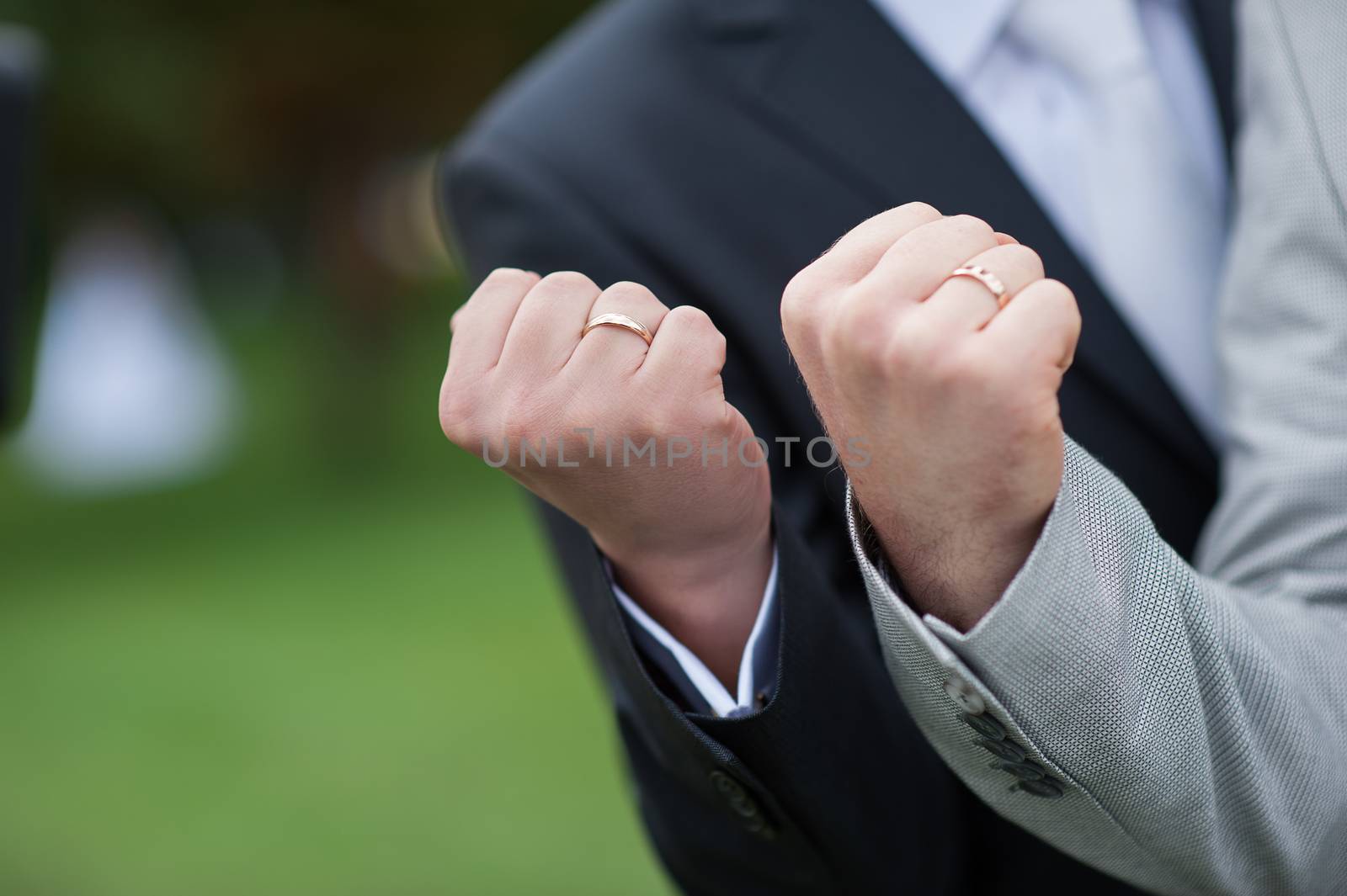 two male fist with wedding gold rings by timonko