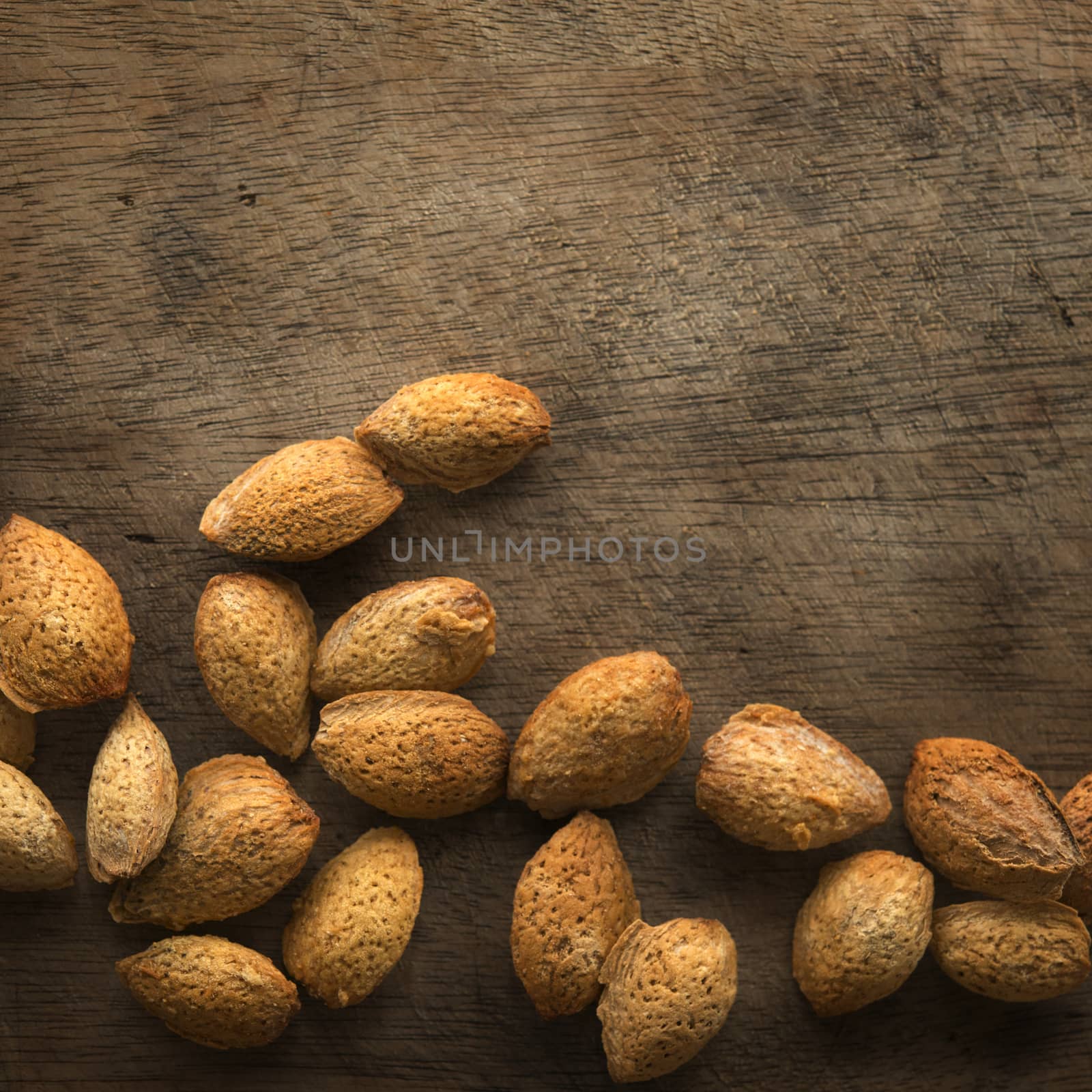 Top view almonds shell on rustic wood background with copy space.