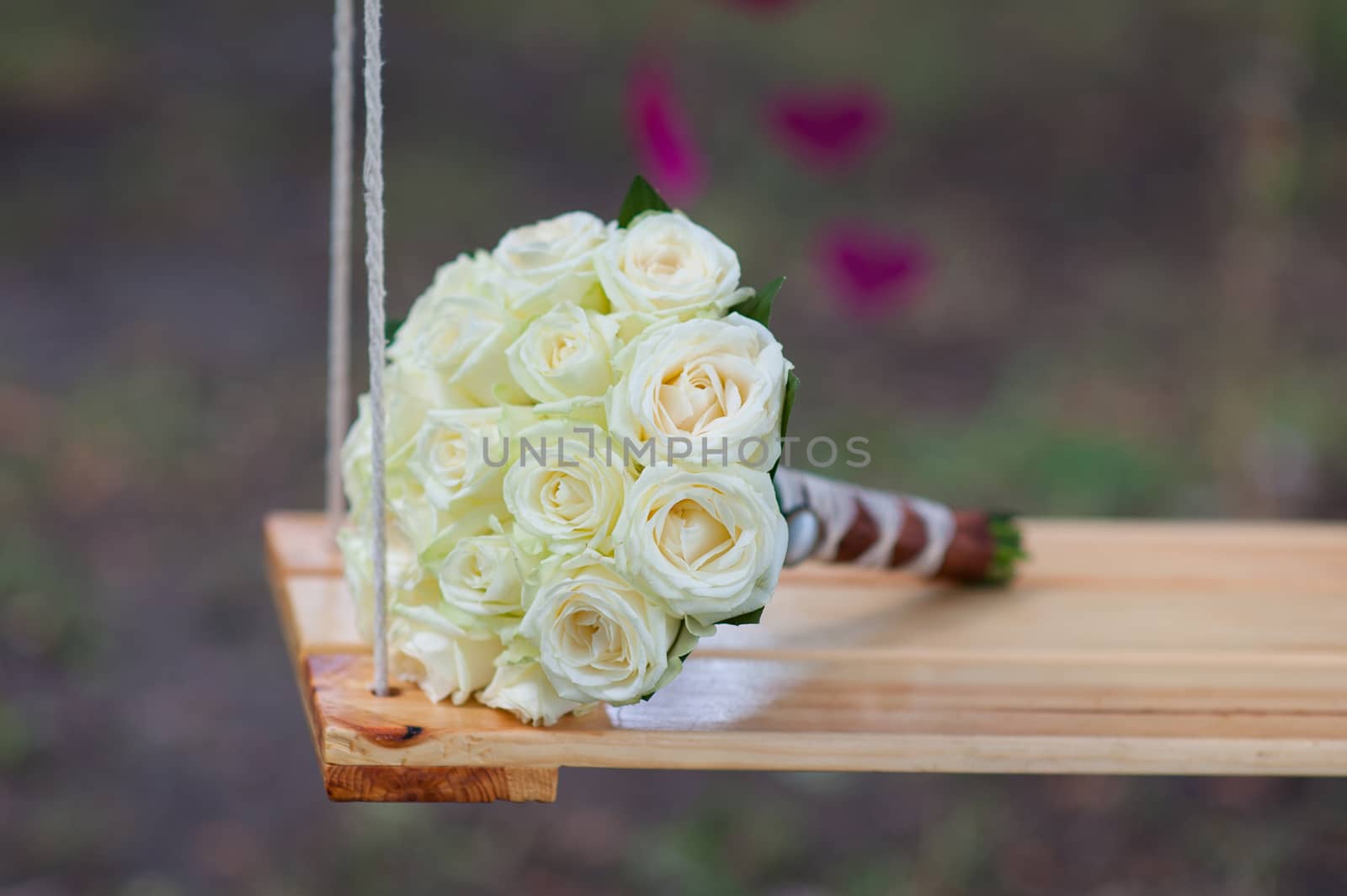 bridal bouquet of white roses on a swing by timonko