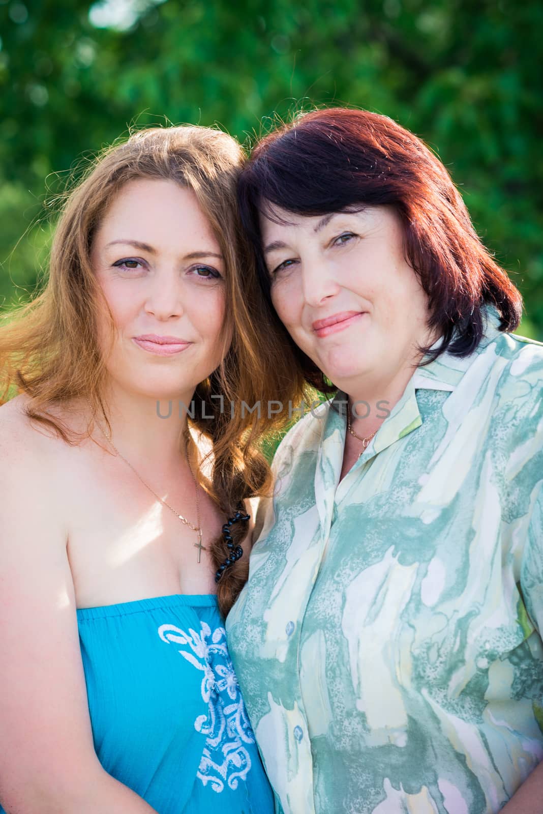 portrait of mother and daughter in summer sunny day