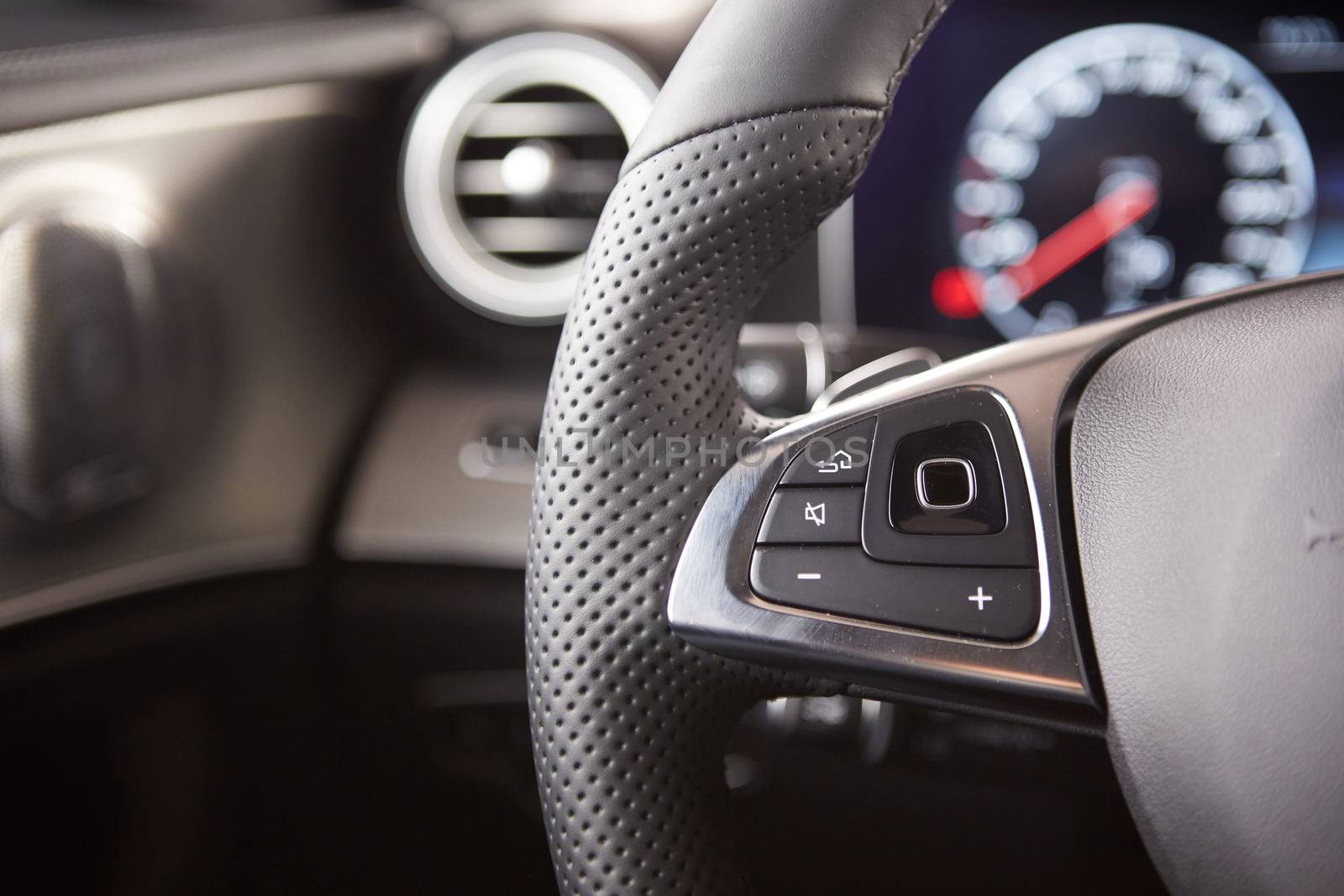 Control buttons on the steering wheel of a car.